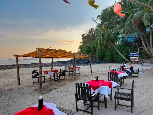The beachside setting of tables and chairs at Aqua Bar in Koh Lanta