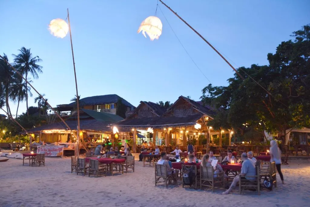 The view of guest seating and dining in one of Kantiang Bay’s beachside restaurants in Koh Lanta
