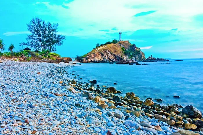 The rocky coastline across the lighthouse in Koh Lanta