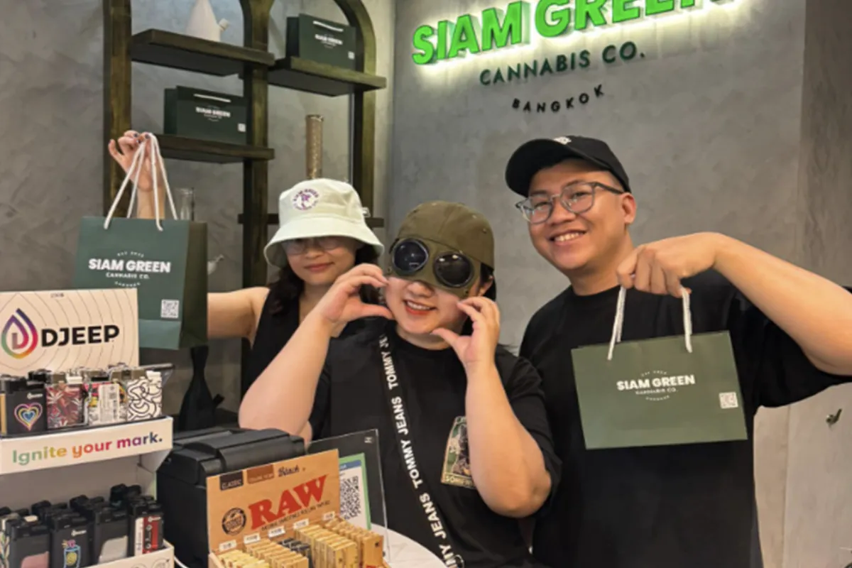 Three customers happily show off their purchases from Siam Green. Co in Bangkok