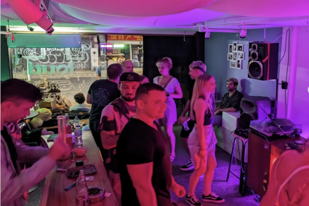 A view inside the Cloud Cannabis Shop, full of customers with live DJ playong on the background