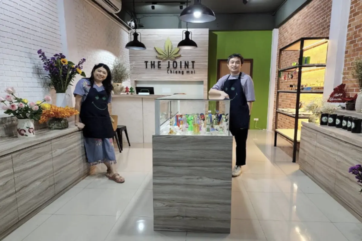 A man and a woman are welcoming customers inside The Joint Cannabis Dispensary in Chaing Mai