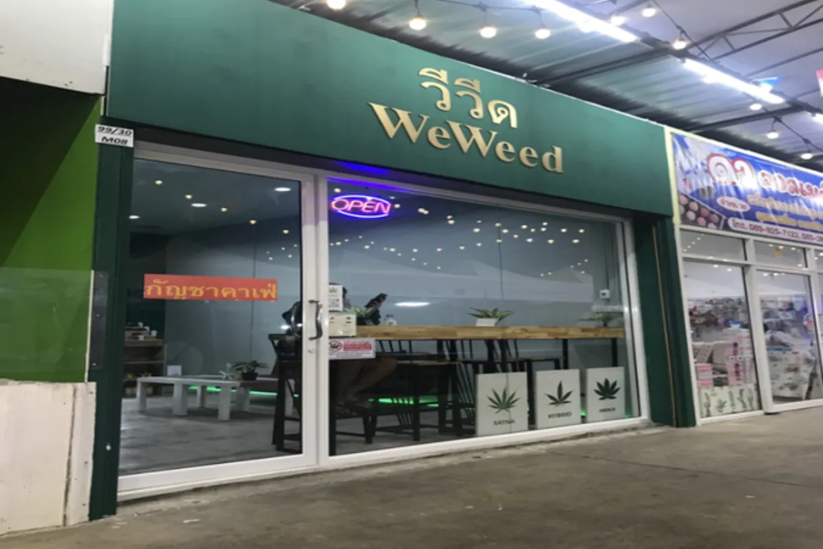 The wide glass storefront of WeWeed Cannabis Cafe near Bangkok Airport Suvarnabhumi