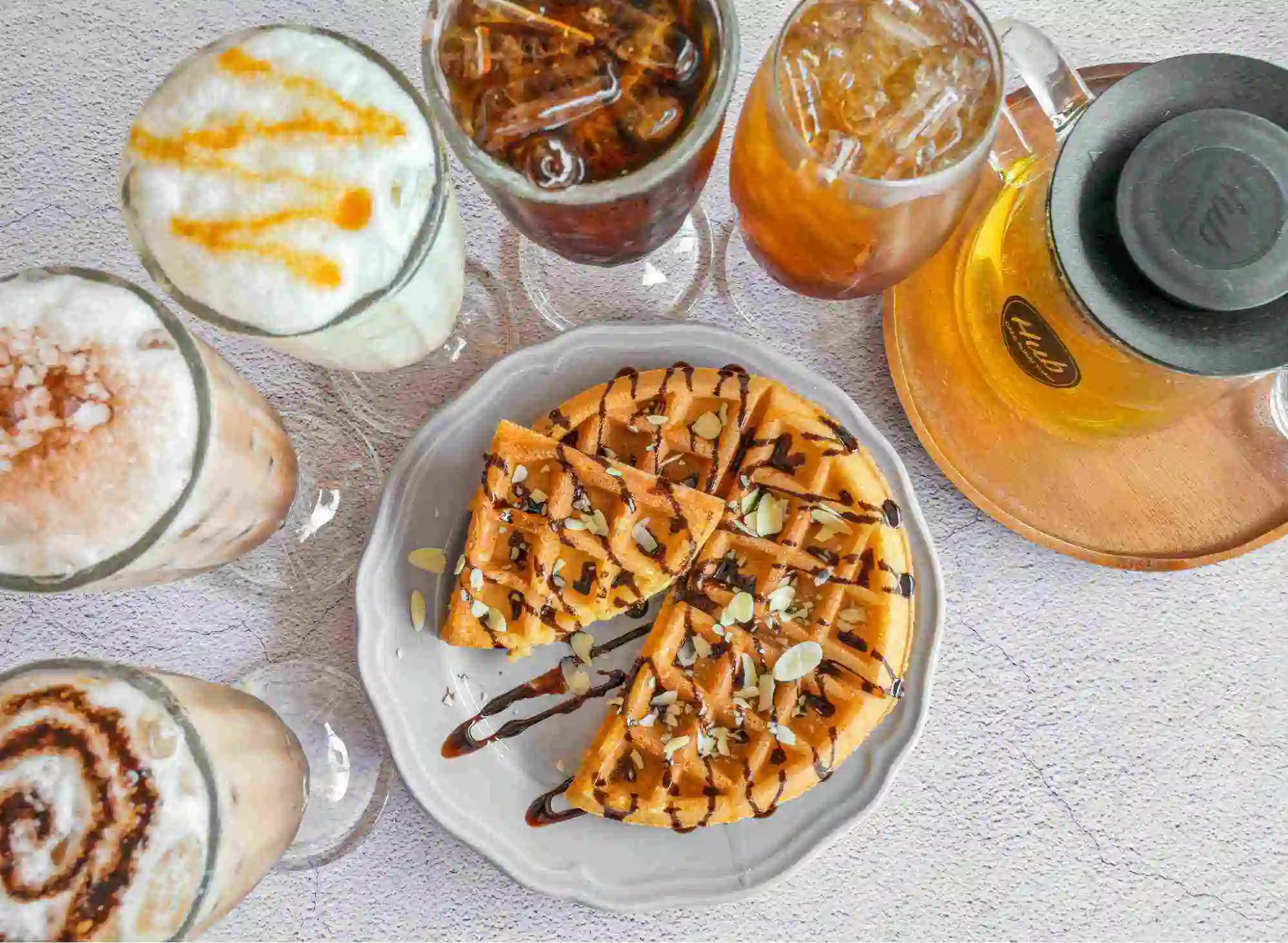 An overhead view of the drinks and waffles served at Hub Cafe in Surat Thani
