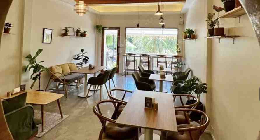 The interior seating area of Kia Ora Cafe in Surat Thani