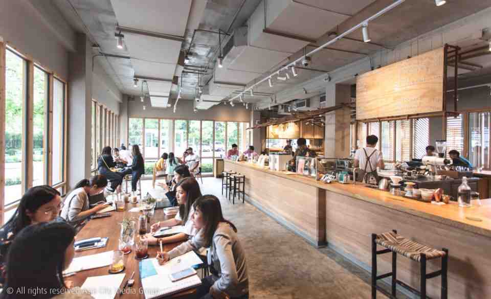 A view inside Roots Cafe filled with customers in Bangkok