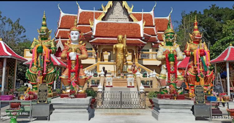 Several colorful statues guarding the entrance of Wat Pothawas temple in Surat Thani