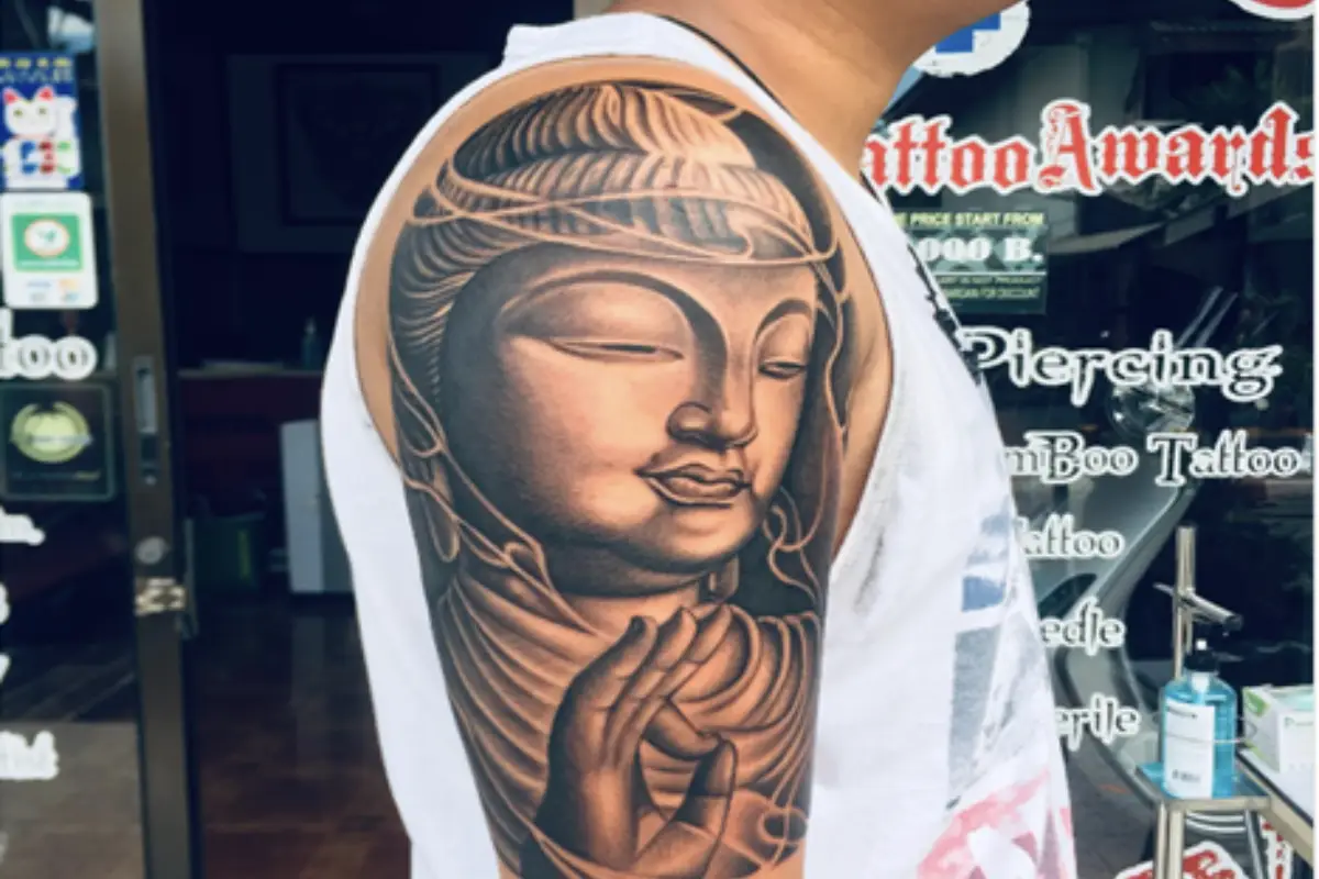 A man showing off his Buddha tattoo done by tattoo artist Owen at By Owen Tattoo studio in Koh Samui