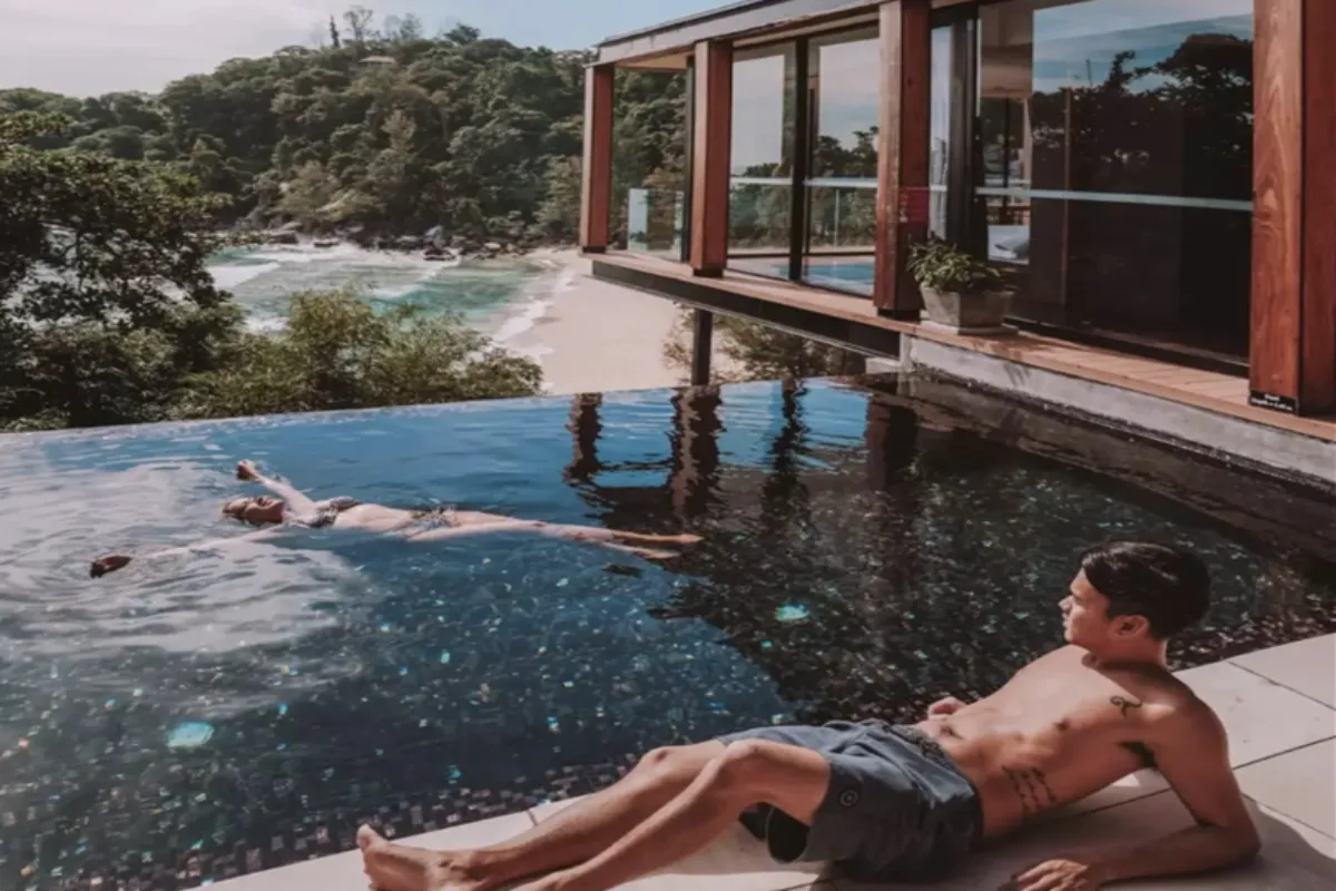 A couple enjoying the swimming pool of The Naka Villa in Phuket