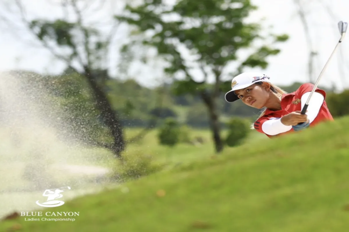 A woman playing golf at the Canyon Course of Blue Canyon Country Club in Phuket.