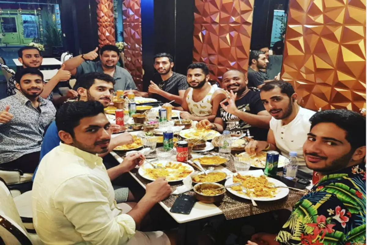 A group of men dining at the Tandoori Flames Restaurant in Phuket