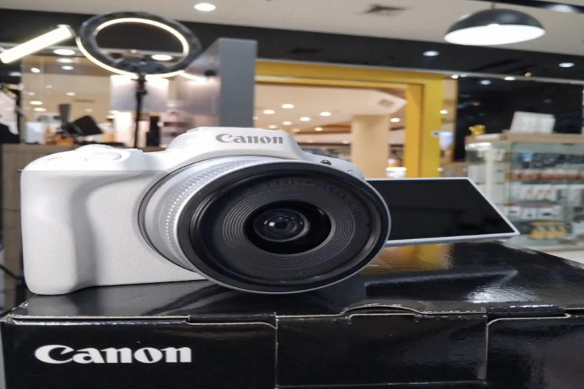 A close-up shot of a white Canon camera being sold at the Digital2Home Store in Chiang Mai