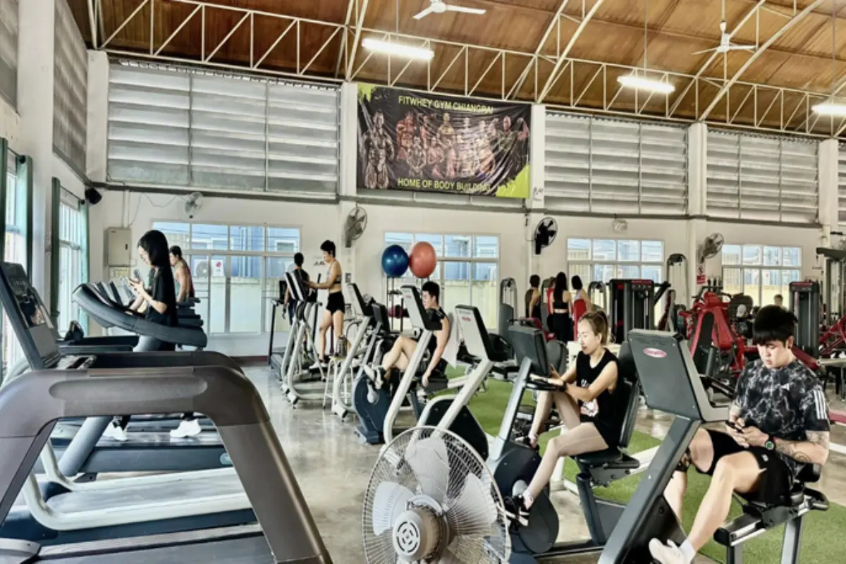 A view inside the Fitwhey Gym with people using the treadmill and the stationary bikes