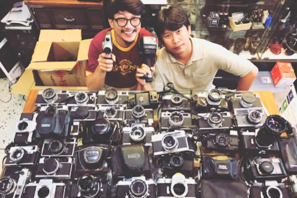 Two men displaying their camera products at NN Camera Shop in Chiang Mai