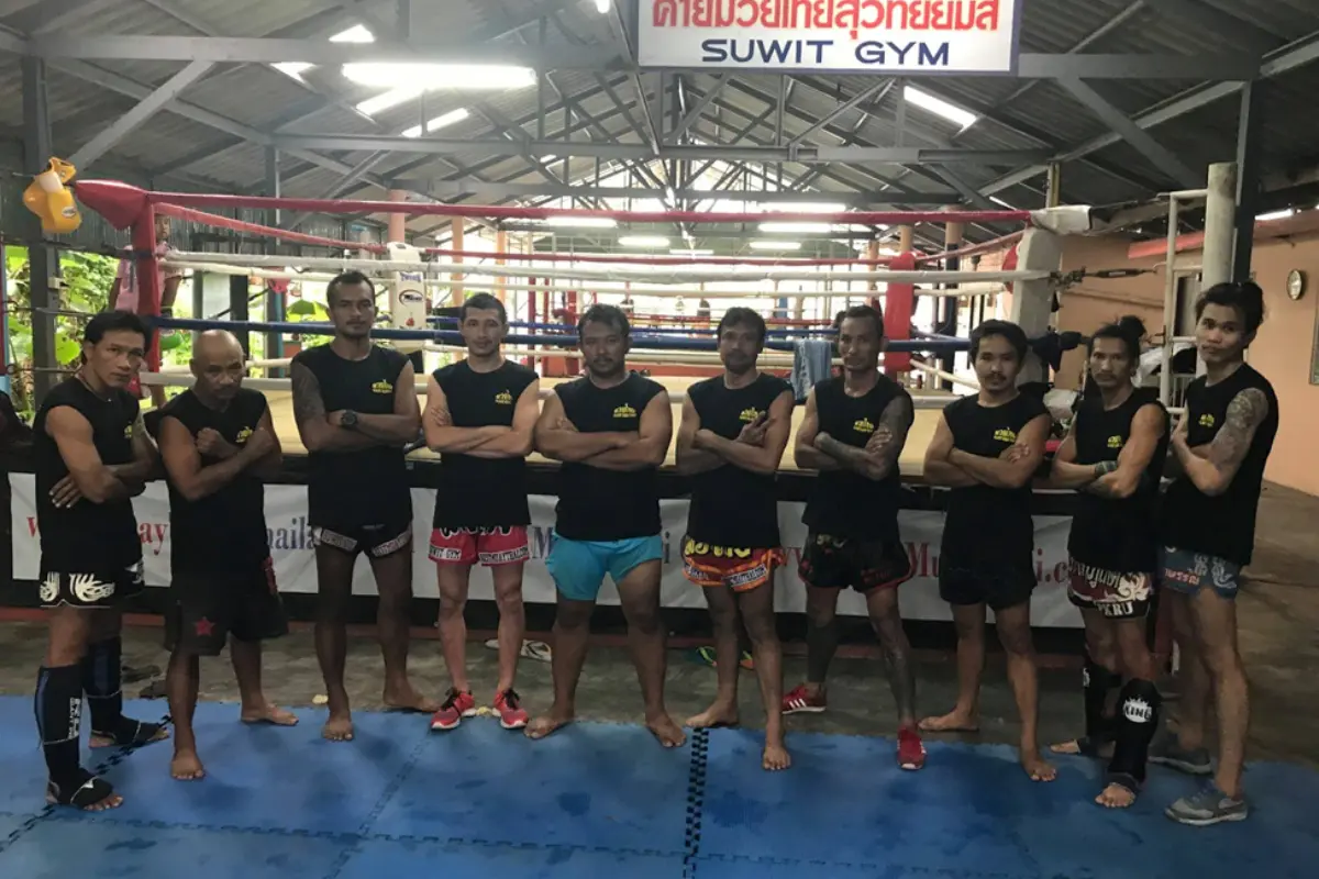 A group of Muay Thai fighters posing together at Suwit Muay Thai Camp.