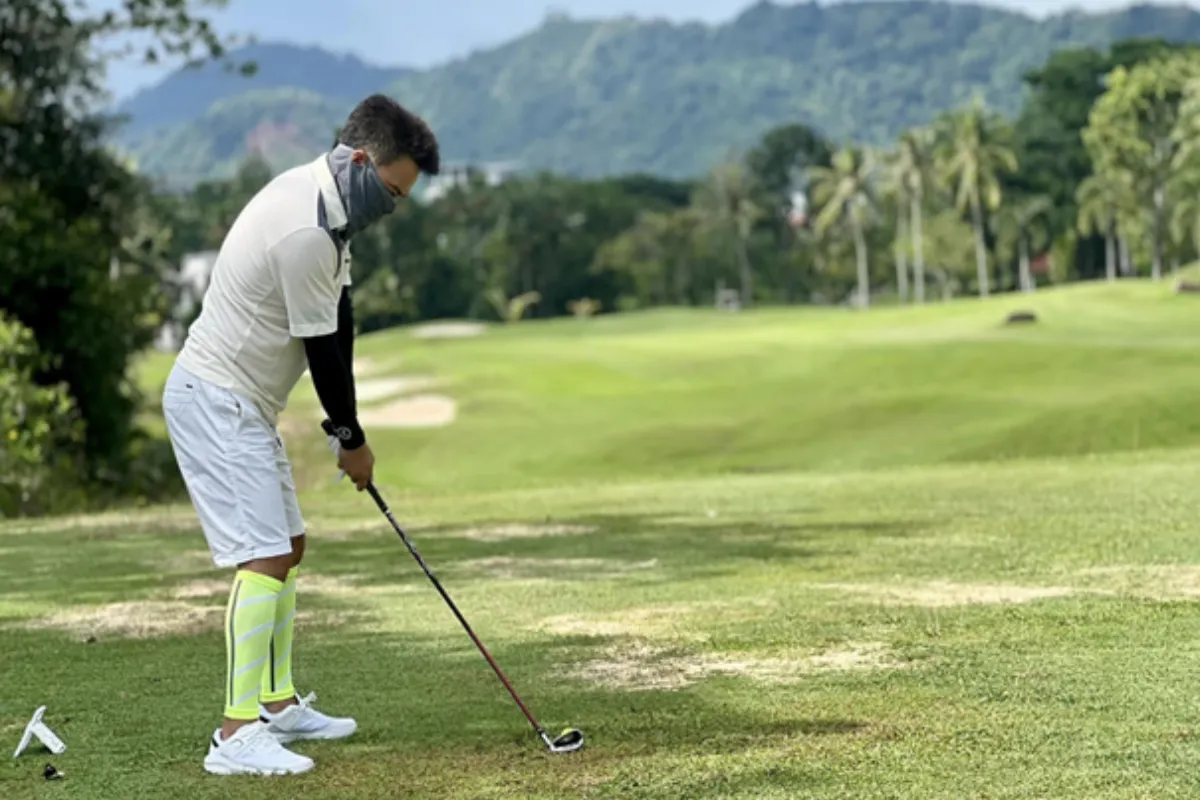 A man is playing golf at Phuket Country Club in Phuket.