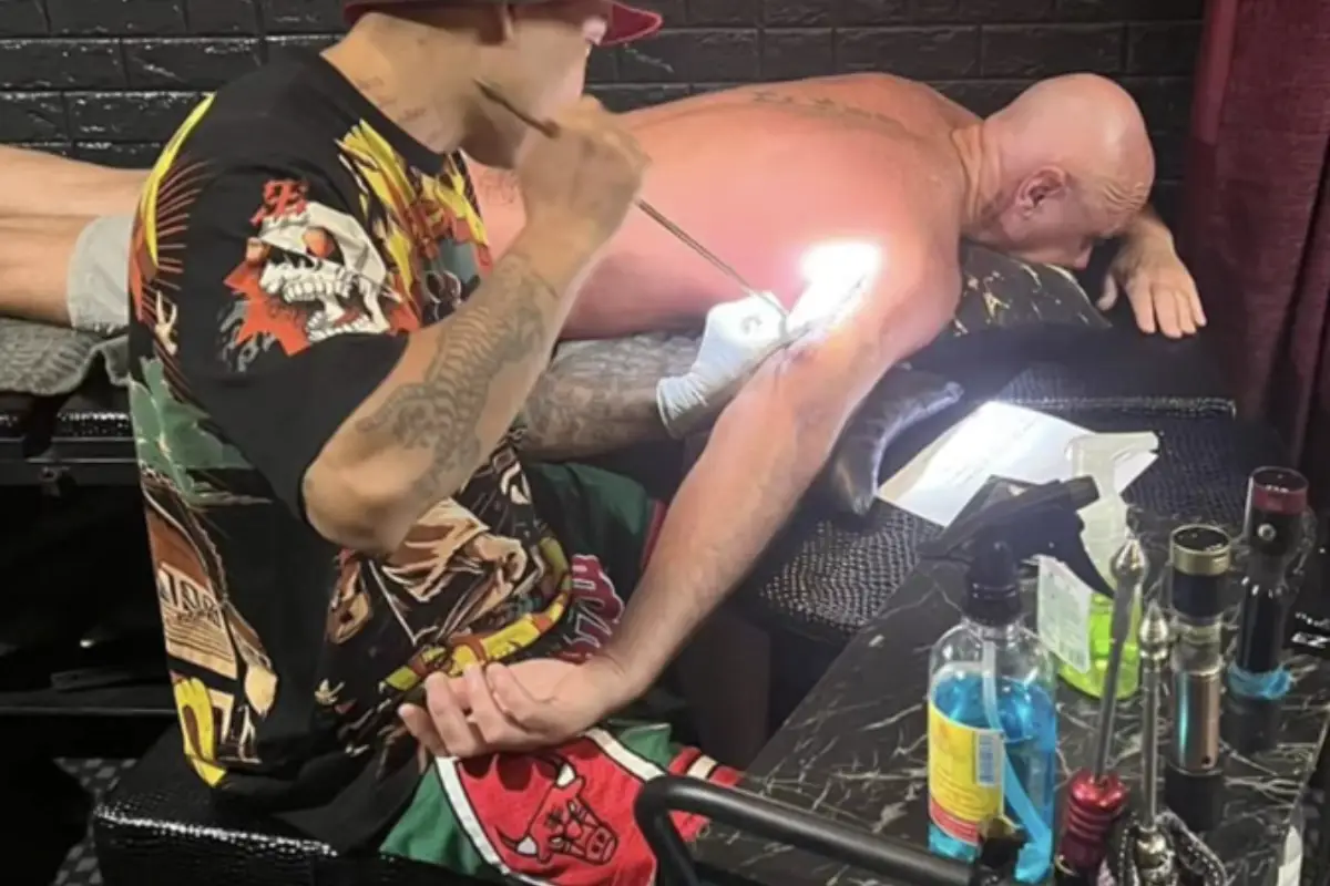 A man getting a sak yant tattoo on his tricep at Wit Tattoo Lamai in Koh Samui