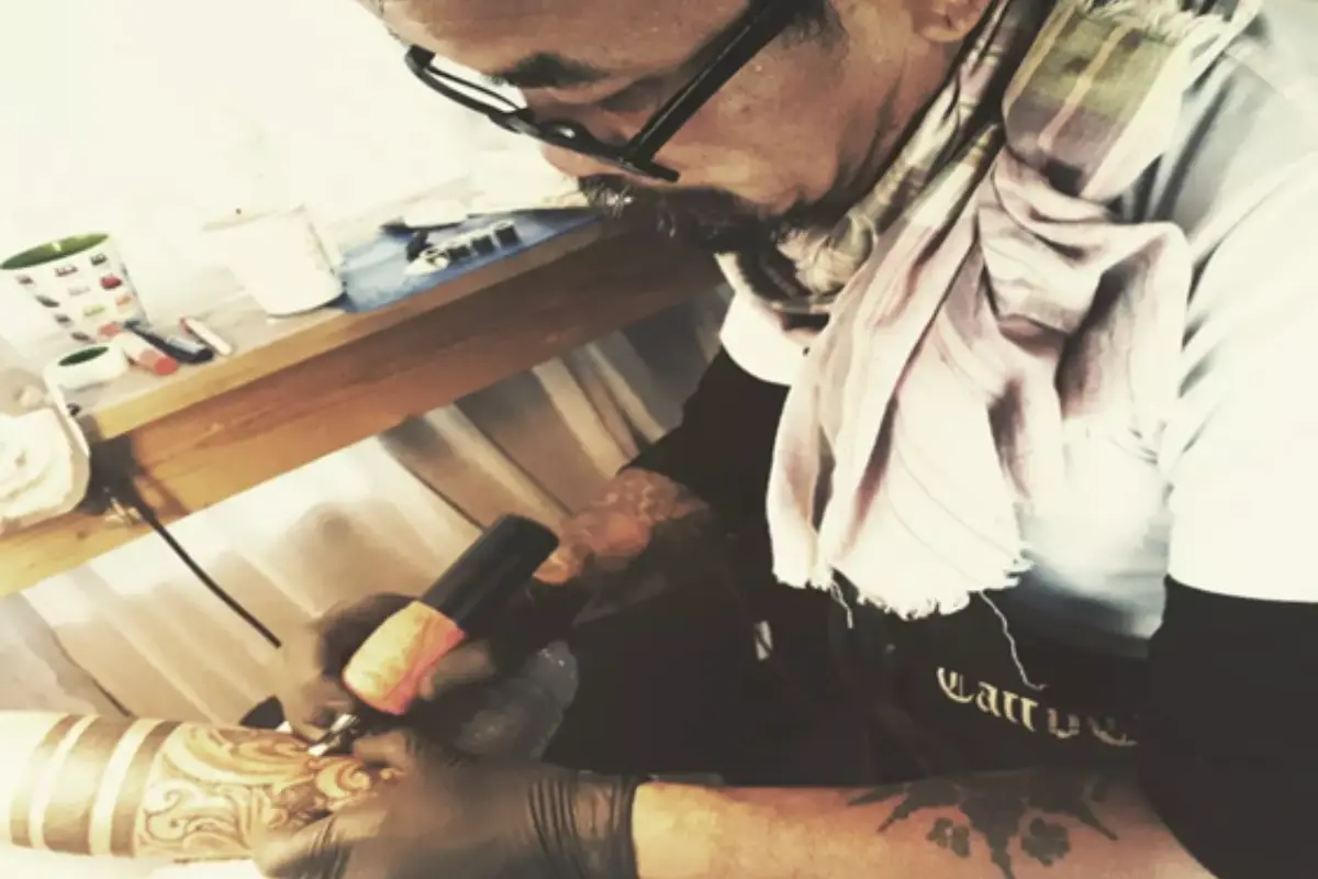 A man is getting his arm tattooed by Mr. Khon at Mr Khon Tattoo Studio in Koh Samui