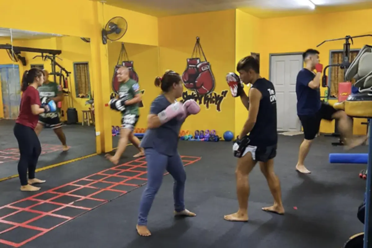 A couple of students having one-on-one training with the instructors of Muay Thai at SkyKick Muay Thai Gym in Chiang Mai