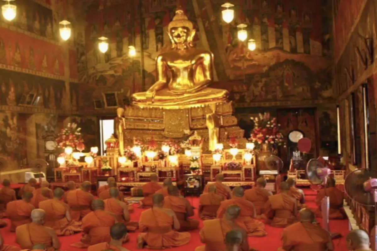 A group of monks praying at Wat Suwannaram in Bangkok