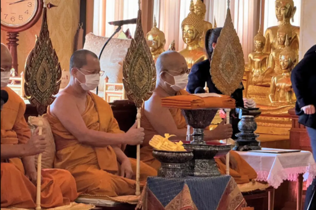 Several monks praying during a ceremony at Wat Kanlayanamit Woramahawihan in Bangkok