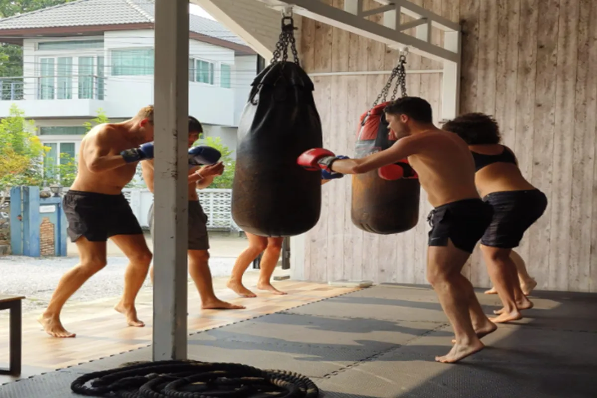 Five people practicing their boxing skills at the Pound Boxing Gym in Chaing Rai