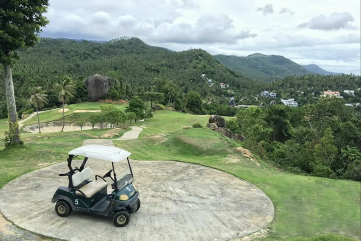 A golf cart is parked on hole 2 par 4 of Royal Samui Golf & Country Club in Koh Samui