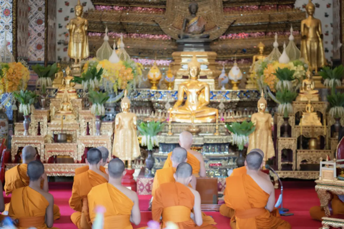 Monks praying inside Wat Arun in Bangkok