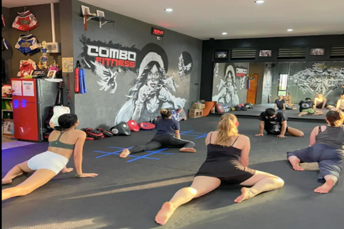 A group of trainees doing warm-up exercises at Combo 4 Fitness Gym in Chiang Rai