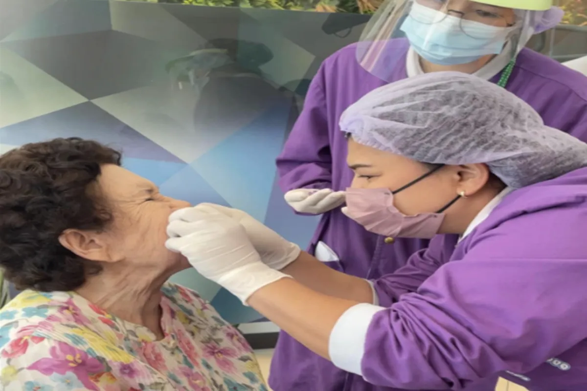 A dentist is checking up the teeth of an elderly woman at the OrthoSmile Dental Clinic in Pattaya