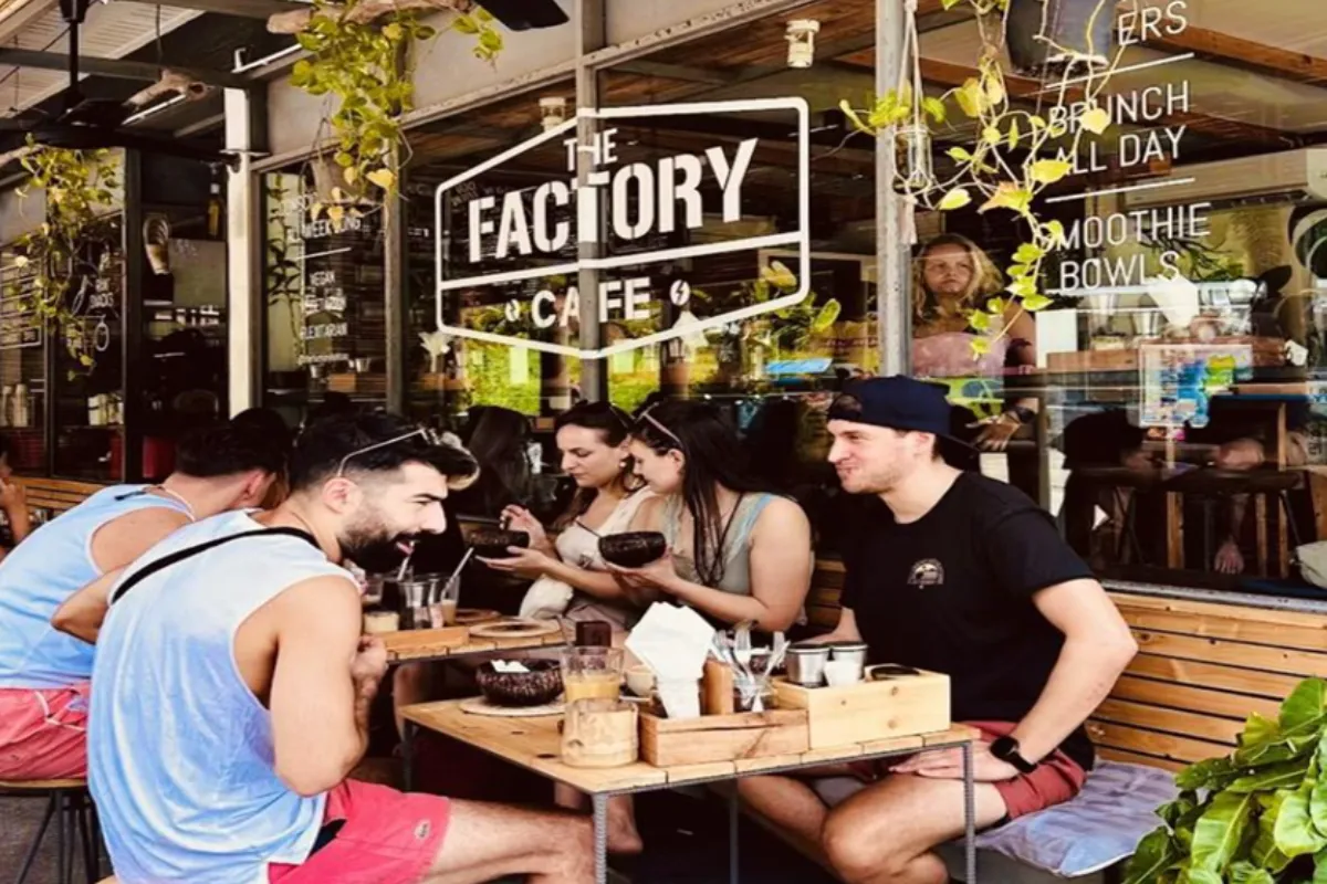 People dining in the outdoor seating area of The Factory Cafe in Koh Tao