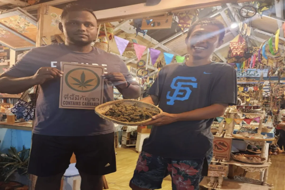Two men showcasing the weed products offered at Namaste Koh Lipe 420 in Koh Lipe