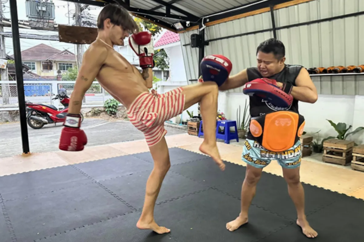 A man is practicing his Muay Thai kicks at Nampetch Muay Thai Gym in Chiang Rai