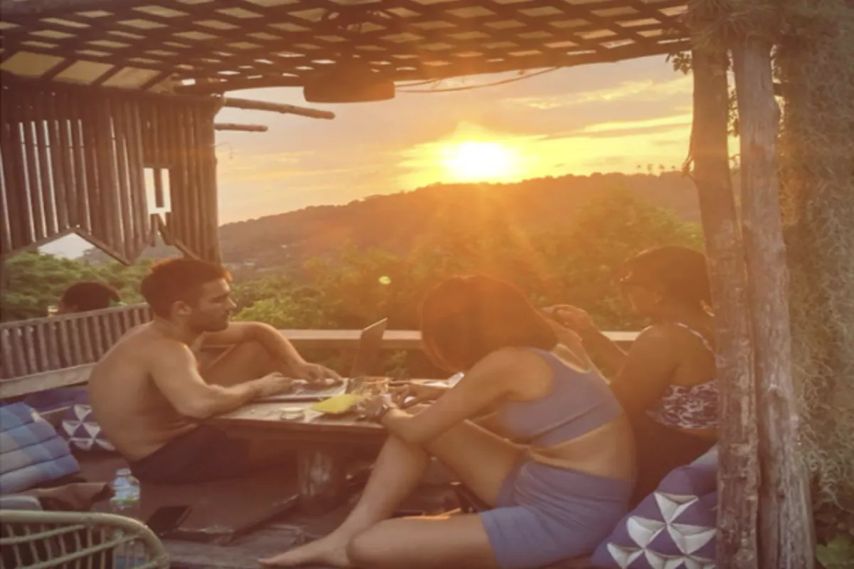 Three people hanging out in the sunset at Natural High Cafe in Koh Tao